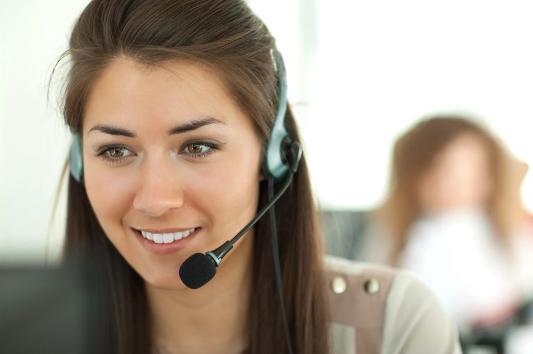 Female customer support operator with headset and smiling